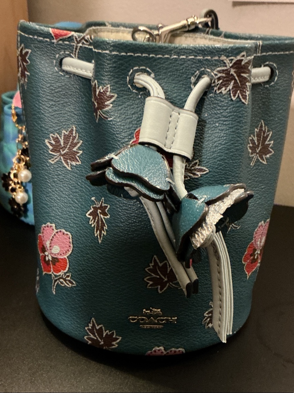 Coach Teal Floral Mini Drawstring Bucket Bag (rim has wear)
